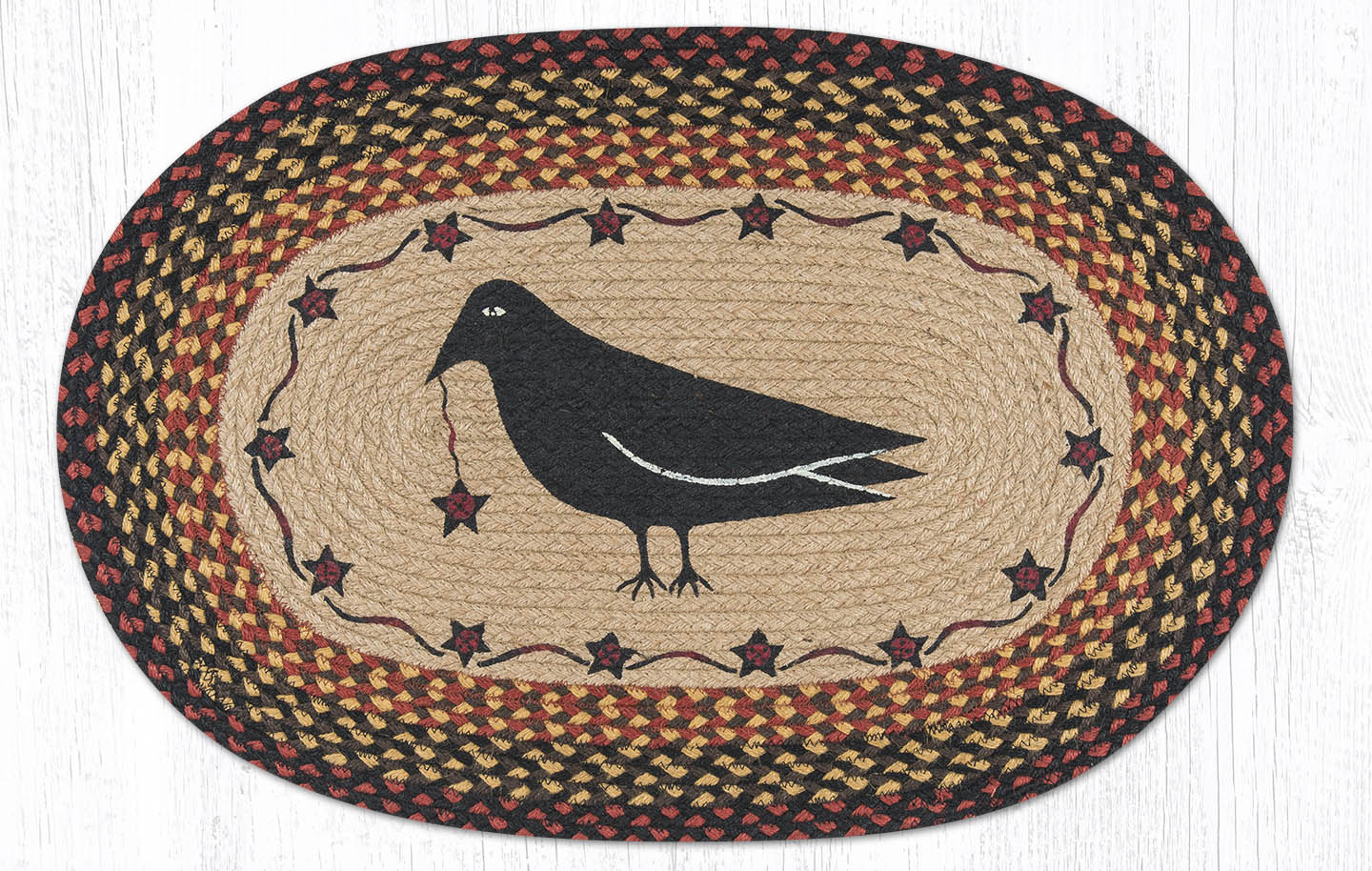 A traditional artisan braided rug depicting a crow in the centre.