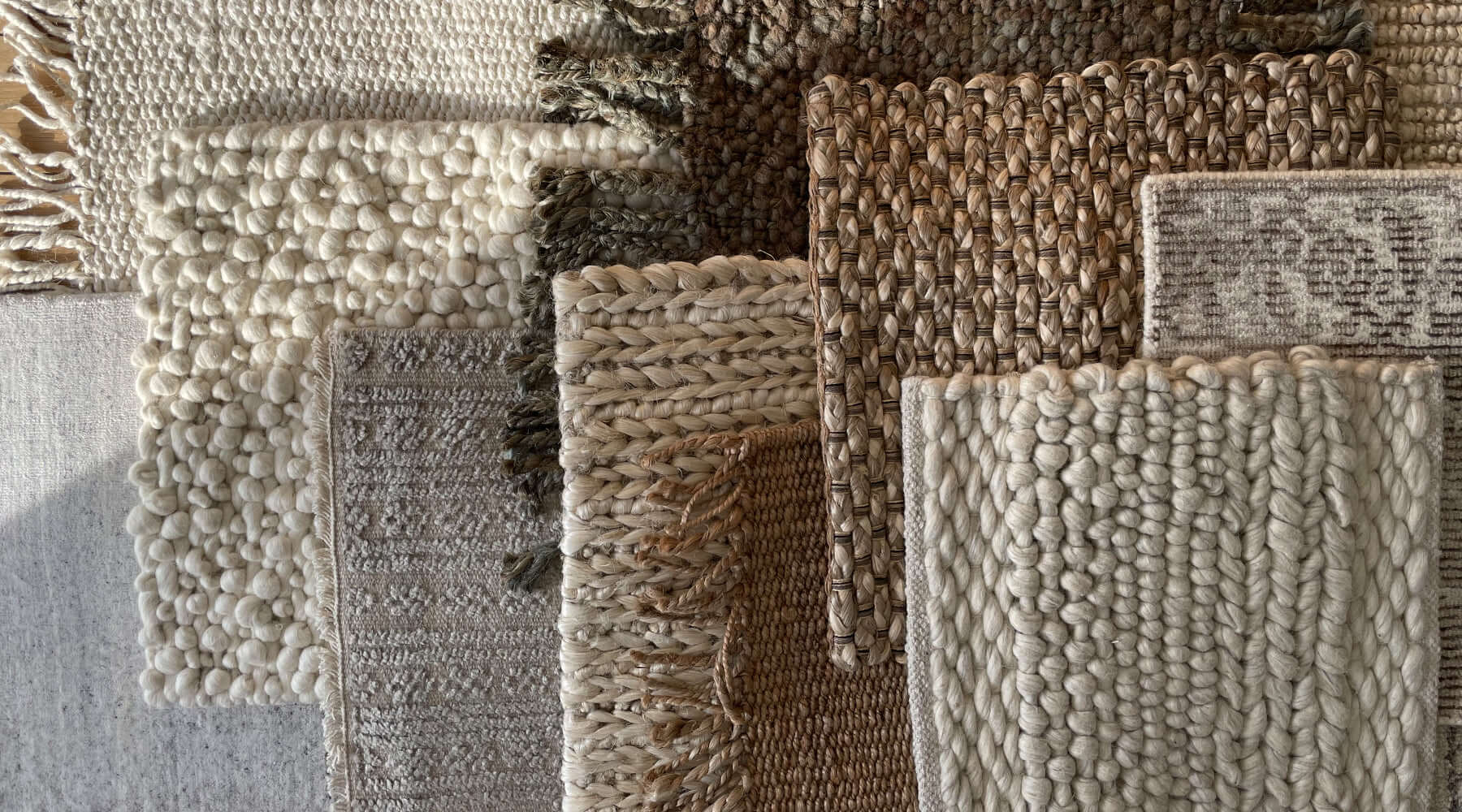 Layers of organic textures and neutral colours show off the craftsmanship of braided wool rugs. 