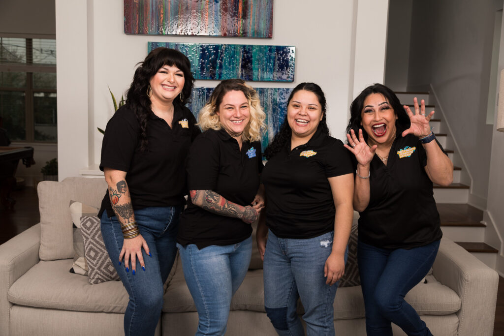 A group photo of four professional Naturalcare Cleaning Service maids in black shirts and blue jeans. How long does move out cleaning service take? Book with one of these professionals to find out more.