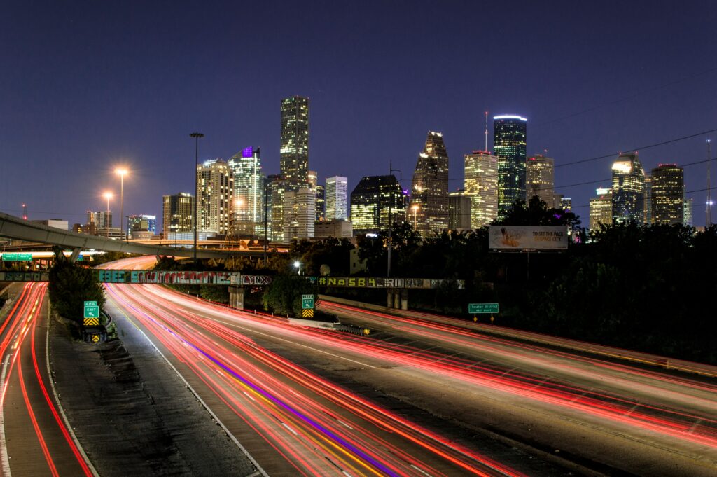 A night view of traffic in Houston TX, where affordable cleaning services are sought after.
