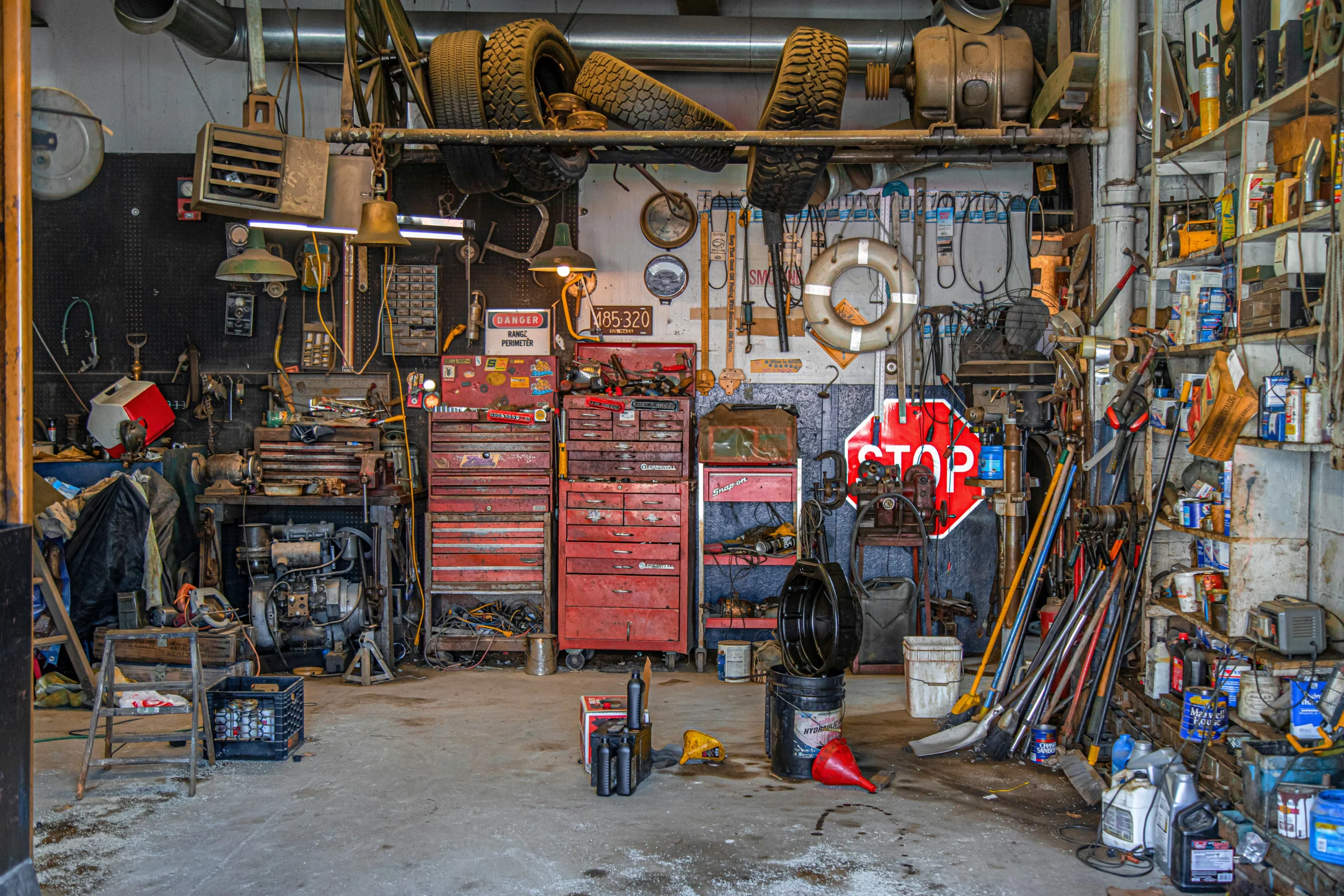 A messy garage from someone who needs garage cleaning tips for the overwhelmed.