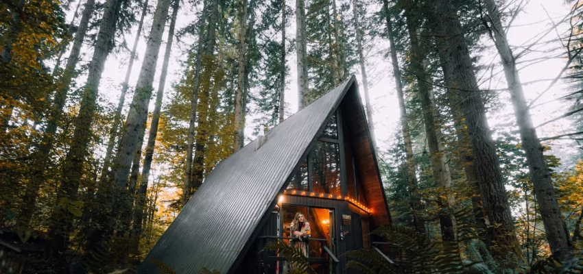 An a-frame cabin in the woods is an Airbnb. Those staying wonder how much do you tip airbnb cleaner?