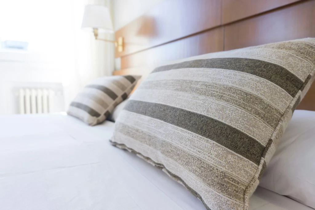 A clean bed with clean pillow shams. The home is stress-free to come back to after getting maid services in Texas.