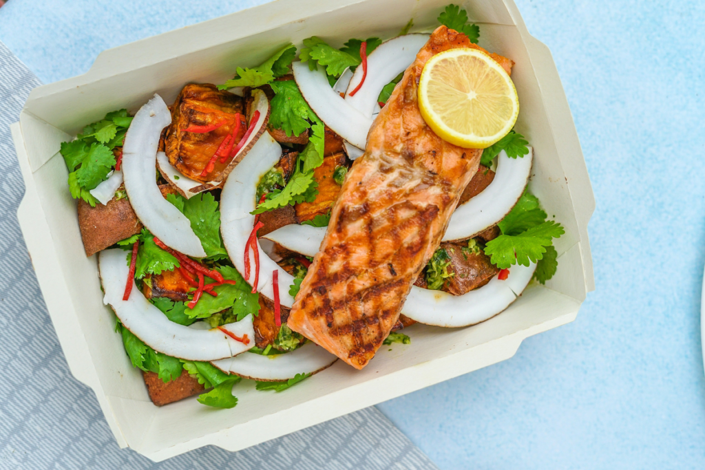 A takeout container full of a fresh dinner, creating no mess for National No Dirty Dishes Day!