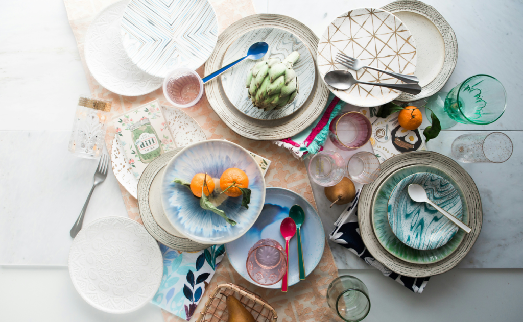 A messy pile of dirty dishes are on a counter, what not to do on National No Dirty Dishes Day.