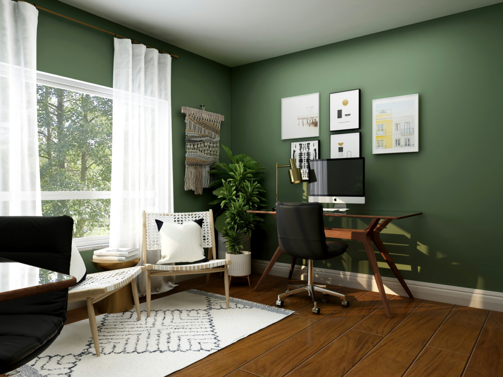 An office with a green interior and lush trees in the window looks spotless after office spring cleaning tips have been deployed.