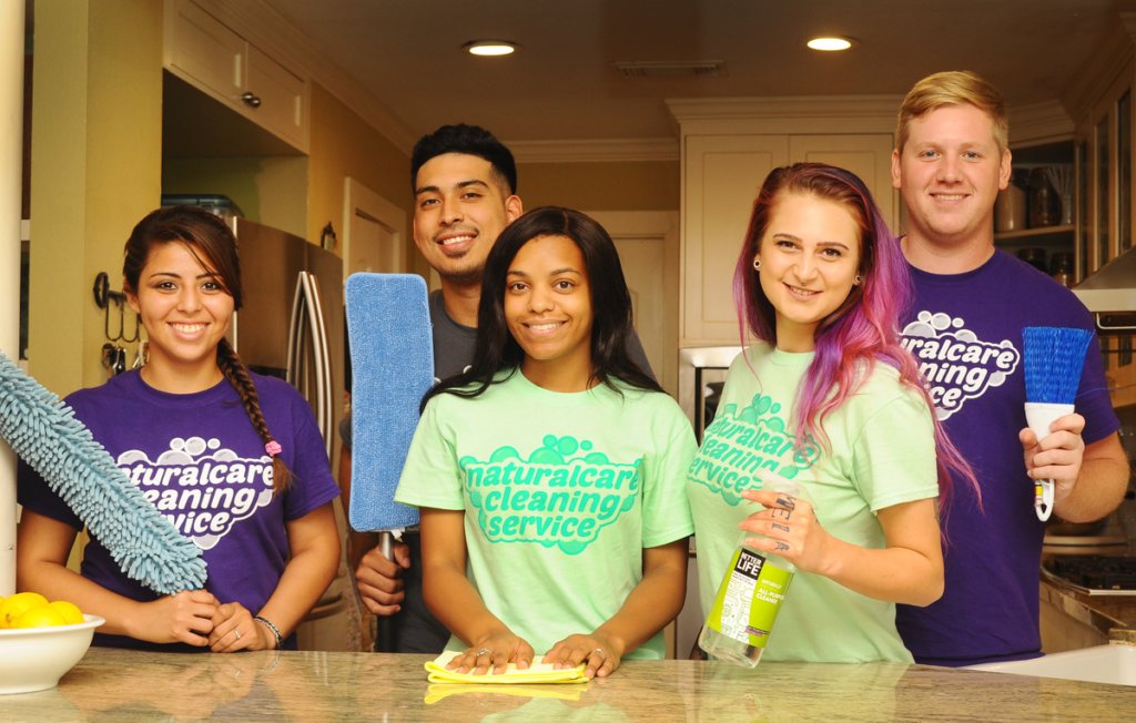 A group of maids from Naturalcare Cleaning services are posing for a group photo in Humble TX.